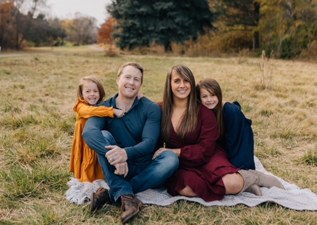 Brad Walker with his wife and two daughters in an Idaho field